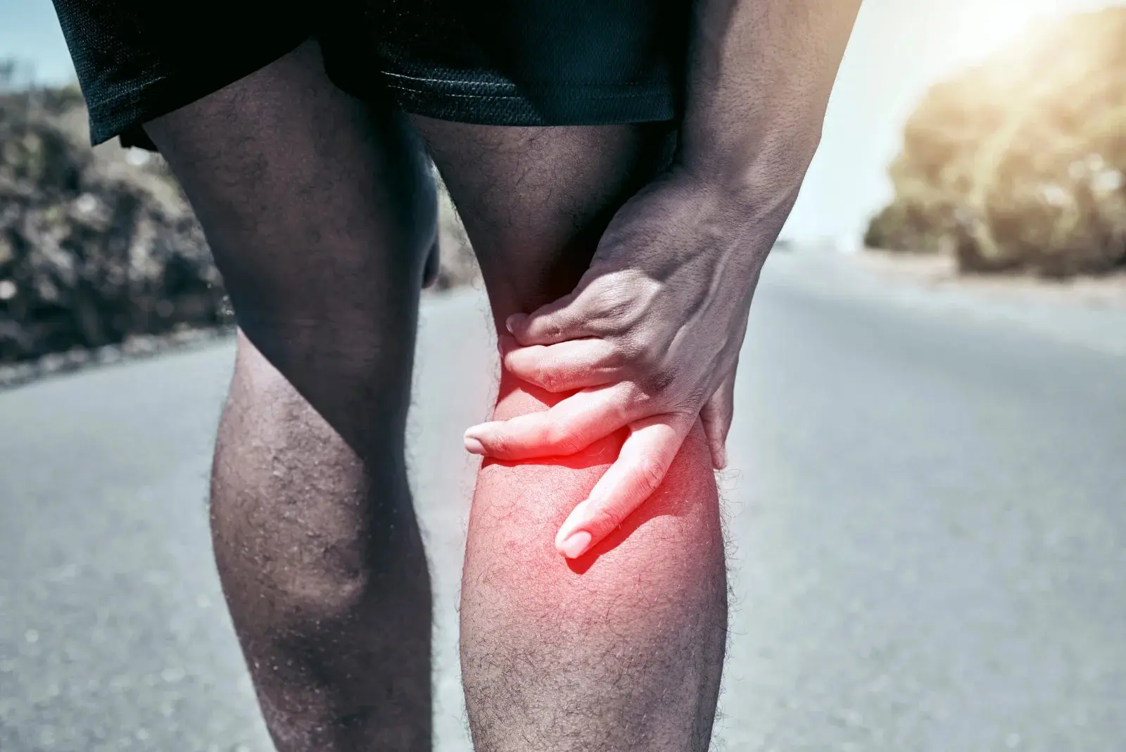 Retatrutide and BPC-157 knee pain research guide | Red Leaf Research Labs Runner holding a painful knee on a road, pain highlighted in red